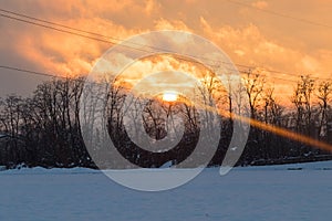 Sunset on a snowy countryside in winter time