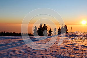 Sunset in the snowy mountains and smog in the valley