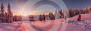 Sunset in the snowy mountains, with two skiers and tourists on the slope