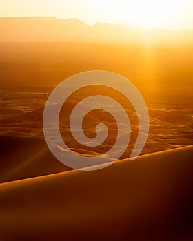 Sunset and speeding car from sand dunes in Erg Chebbi, Morocco photo