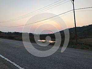 Sunset Splendor: Endless Road, Blue Sky, and Orange Hues