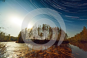 Sunset and Star Trails Over Lake