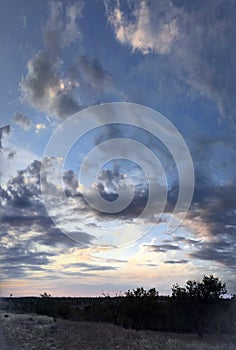 Sunset in the steppe, blue sky, clouds, sundawn.