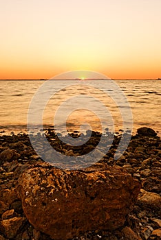 Sunset, stones and shoreline