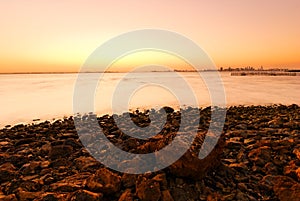 Sunset, stones and shoreline