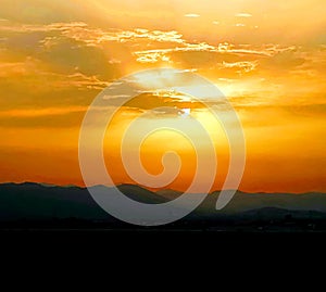 Sunset with storm clouds over mountains