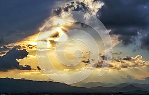 Sunset with storm clouds over mountains