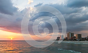 Sunset on a summer day with beautiful clouds at Praia da Barra da Tijuca Beach, Rio de Janeiro, Brazil.