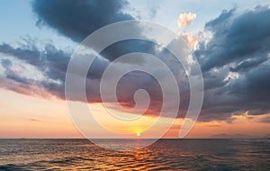 Sunset on a summer day with beautiful clouds at Praia da Barra da Tijuca Beach, Rio de Janeiro, Brazil.