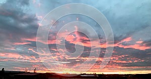 Sunset in the summer in the East of England. A layered gold and white sunset overlooking a nature reserve.