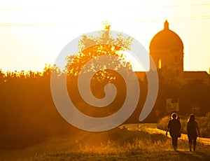 Sunset in summer with silhouette of church dome, Italy