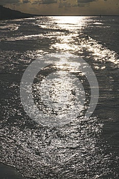 Sunset - sun reflecting in waves, shore