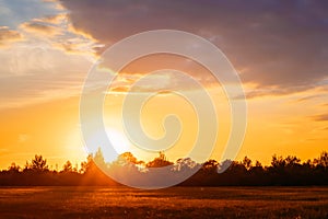 Sunset, Sunrise Over Rural Field Meadow. Bright Dramatic Sky