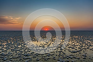 Sunset or sunrise on salt lake Elton (Russia) with mirror