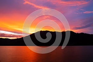 Sunset or sunrise sky clouds over mountains,Beautiful reflex sunset or sunrise light in water surface,Amazing nature landscape