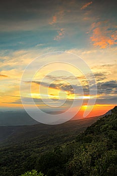 Sunset sunrise twilight sky cloud color background with forest mountain hill landscape in national park Thailand