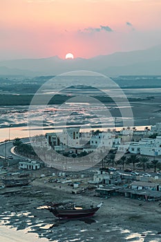 Sunset in Sur town. View on west part of the Sur city, Oman