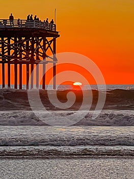 sunset and surf at a california pier