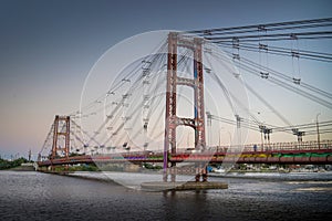Silhouette Puente Colgante Ing Marcial Candioti Over Santa Fe River Against Sky photo
