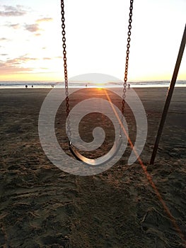 Sunset through the swing at Pismo Beach