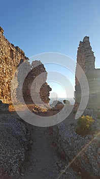 Sunset betwen ruins on the top of a mountain photo