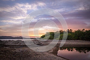 Sunset at Tambor Beach, in the Pacific of Costa Rica, next to the mouth of the Pochote River photo