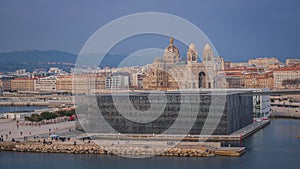 Sunset timelapse over the Major Cathedral and Fort Saint-Jean at the entrance of ole port in Marseille, France