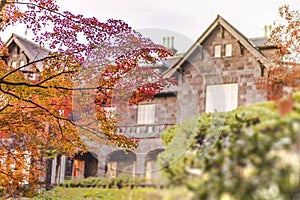 Sunset on Tokyo Metropolitan Park KyuFurukawa`s old western-style mansion at red maple momiji leaves season in autumn