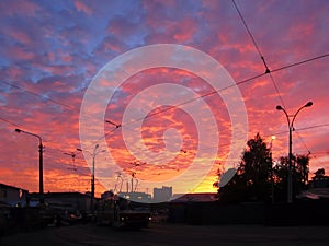 Sunset tomorrow. Black street lights, tram on tramway photo