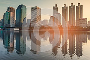 Sunset tone, city office building over water reflection