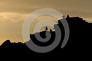 Sunset tourism at stanage edge, a couple take a selfie, climbers too