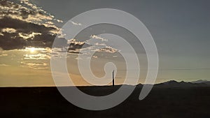 Sunset train clouds skyline glow cloud mountain with powerline and light rays