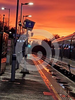 Sunset with a train on a railway platform