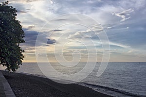 Sunset on tropical black sand beach