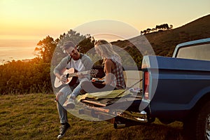 Sunset, truck or couple with guitar in nature on romantic holiday vacation for bonding or relaxing on date. Car road