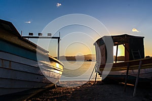 Sunset and two fishing boats at the Abraao beach - Florianopolis - Brazil