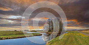 Sunset typical Dutch polder landscape in polder Zaans Rietveld along N11