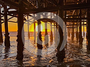 sunset under an ocean pier