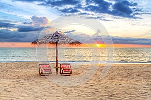 Sunset under parasol on the beach