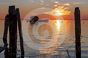 Sunset on the Venetian lagoon with the fishermen's houses, Pellestrina island, Venetian lagoon, Italy