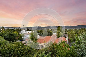 Sunset view behind a spacious house and trees in Encino, California