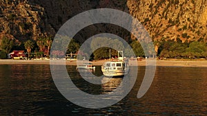 Sunset view of a boat in Butterfly Valley, ,Oludeniz, Turkey. A mediterranean sea and beach