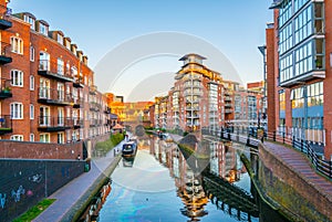 Sunset view of brick buildings alongside a water channel in the central Birmingham, England
