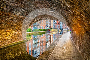 Sunset view of brick buildings alongside a water channel in the central Birmingham, England