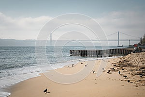 Sunset view of Bridge of 25th April and National sanctuary of Cristo Rei in Lisbon, Portugal