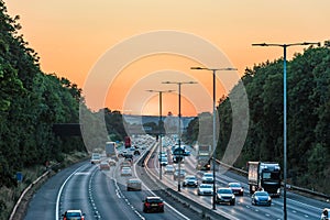 Sunset view of busy UK Motorway traffic in England