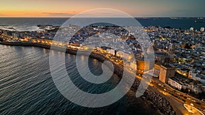 Sunset view of Cadiz with city lights, Andalusia, Spain . Great aerial view of evening Cadiz and Catedral de Santa Cruz photo