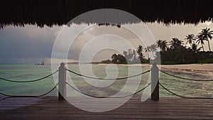 Sunset view of Caribbean sea and rainbow from wooden pier, Punta Cana resort