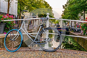 Sunset view of a channel in Delft and bicycles, Netherlands