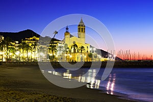 Sunset view of church at beach. Sitges